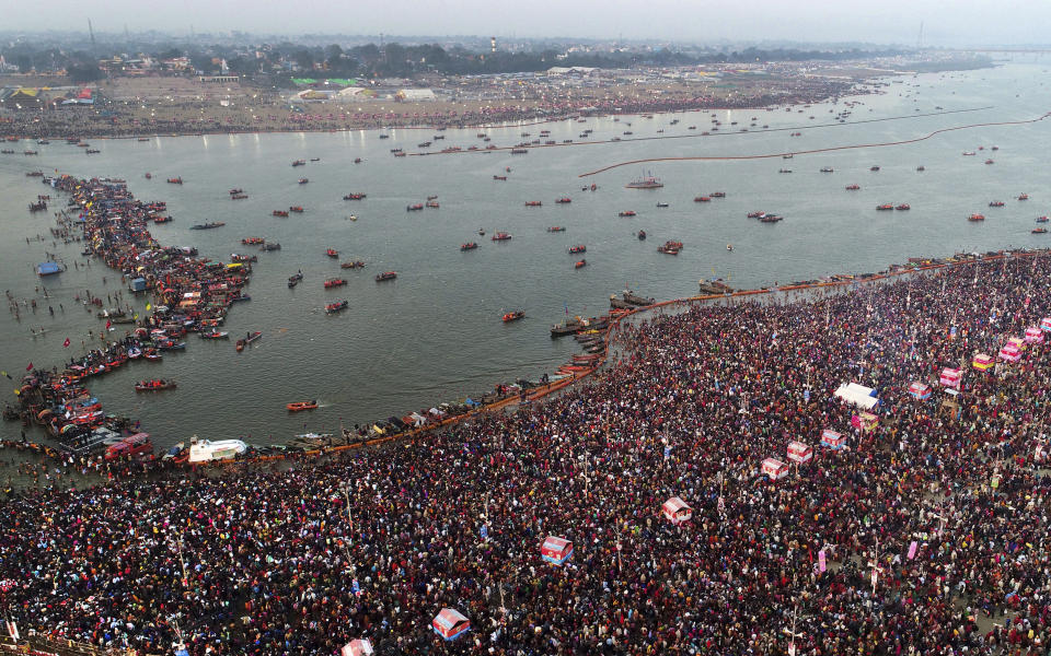 In this Sunday, Feb. 10, 2019, file photo, thousands of Hindu pilgrims take a ritualistic dip on the auspicious day of Basant Panchami at Sangam, the confluence of sacred rivers the Yamuna, the Ganges and the mythical Saraswati, during the Kumbh Mela or the Pitcher Festival, in Prayagraj, Uttar Pradesh state, India. The Kumbh Mela is a series of ritual baths by Hindu sadhus, or holy men, and other pilgrims at Sangam that dates back to at least medieval times. Pilgrims bathe in the river believing it cleanses them of their sins and ends their process of reincarnation. (AP Photo/Rajesh Kumar Singh, File)