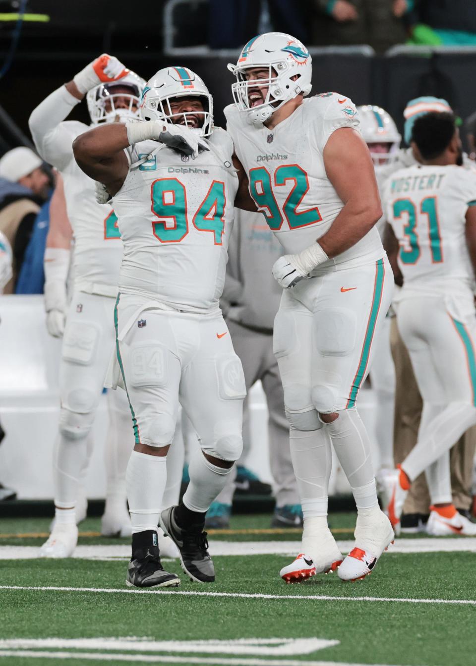 Nov 24, 2023; East Rutherford, New Jersey, USA; Miami Dolphins defensive tackle Christian Wilkins (94) and defensive tackle Zach Sieler (92) celebrate after a defensive stop during the second half against the New York Jets at MetLife Stadium. Mandatory Credit: Vincent Carchietta-USA TODAY Sports