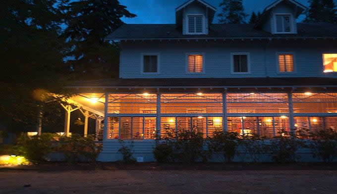 The lights glow through the divided windows of the dining room at Lake Crescent Lodge.