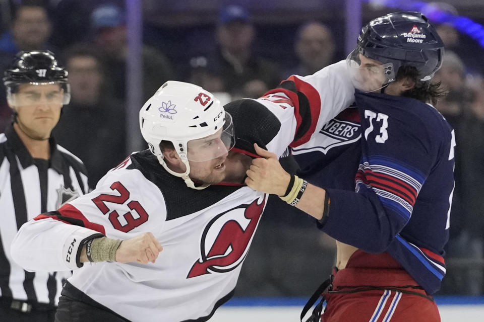 New Jersey Devils defenseman Kurtis MacDermid (23) fights New York Rangers center Matt Rempe (73) during the first period of an NHL hockey game, Wednesday, April 3, 2024, at Madison Square Garden in New York. (AP Photo/Mary Altaffer)