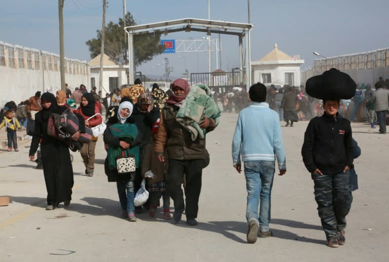 Syrians fleeing the northern embattled city of Aleppo wait at the Bab al-Salama crossing on the border with Turkey, on February 5, 2016