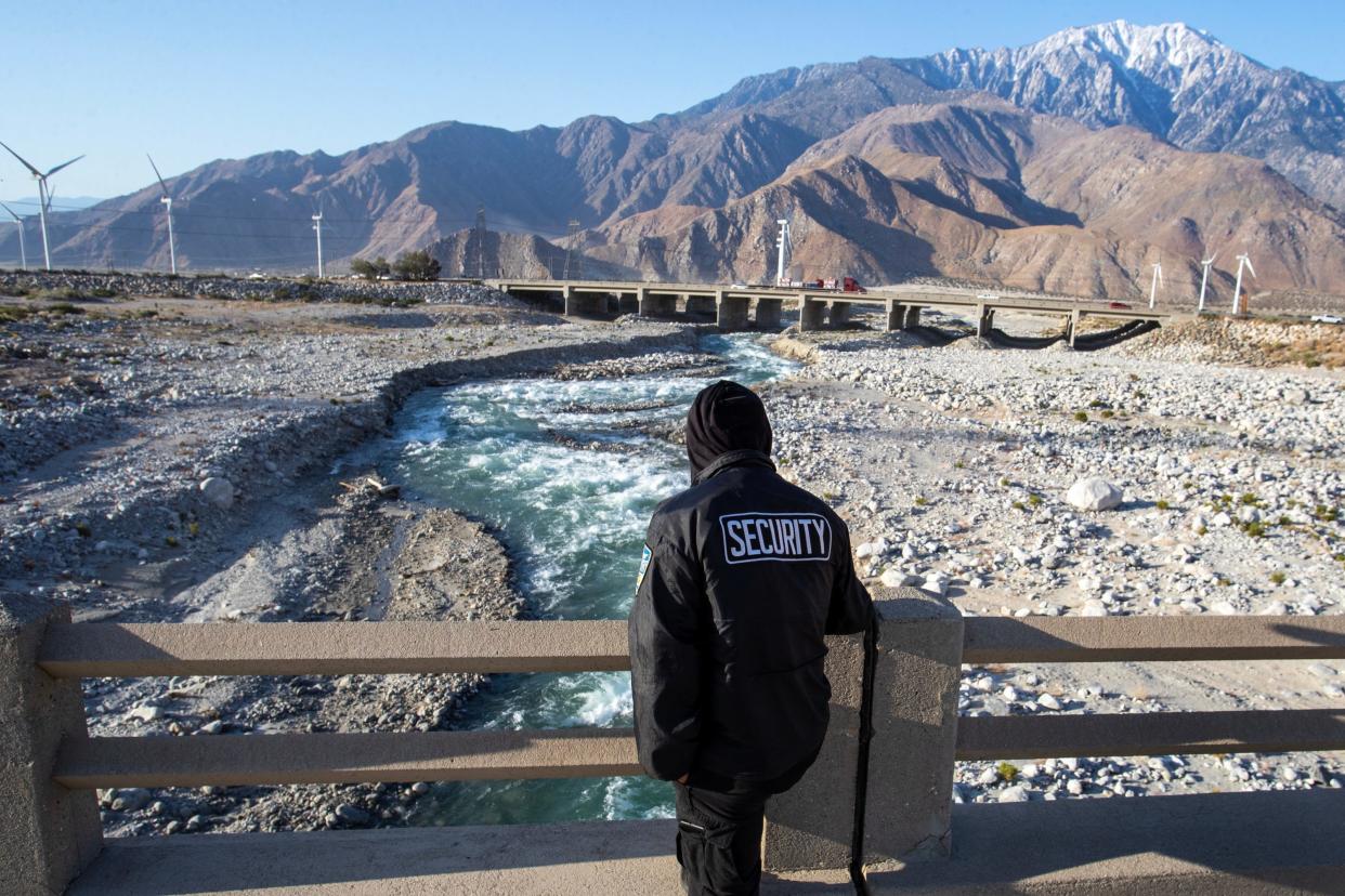 Two weeks into his assignment as a private security guard hired to keep people out of the Whitewater River channel, Ramon Cordova of La Quinta, says he's turned away occupants of 15-20 vehicles daily from stopping near the Whitewater Cutoff bridge. "I'm like a lifeguard," Cordova said, in Whitewater, Calif., on Wed., May 10, 2023. He hands them a flyer in both English and Spanish, provided by the Coachella Valley Water District, about trespassing and most importantly the risks to their lives if attempting to enter the fast-moving river.