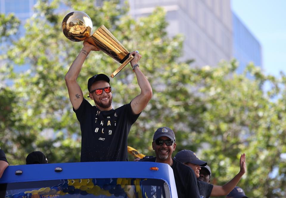 <p>Golden State Warriors Stephen Curry holds the Larry O’Brien NBA Championship Trophy during the Warriors Victory Parade on June 15, 2017 in Oakland, California. An estimated crowd of over 1 million people came out to cheer on the Golden State Warriors during their victory parade after winning the 2017 NBA Championship. (Photo by Justin Sullivan/Getty Images) </p>