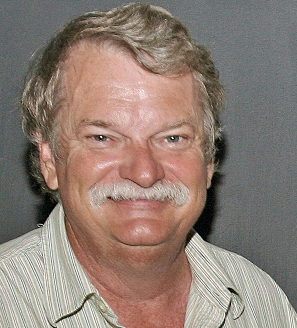 FILE - In this undated file photo, Alabama Staff Photographer Dave Martin poses for a photo in Georgia. Martin, a longtime Associated Press photographer based in Montgomery, Ala., died after collapsing on the Georgia Dome field at the Chick-fil-A Bowl on Tuesday, Dec. 31, 2013. Martin was 59. (AP Photo/File)