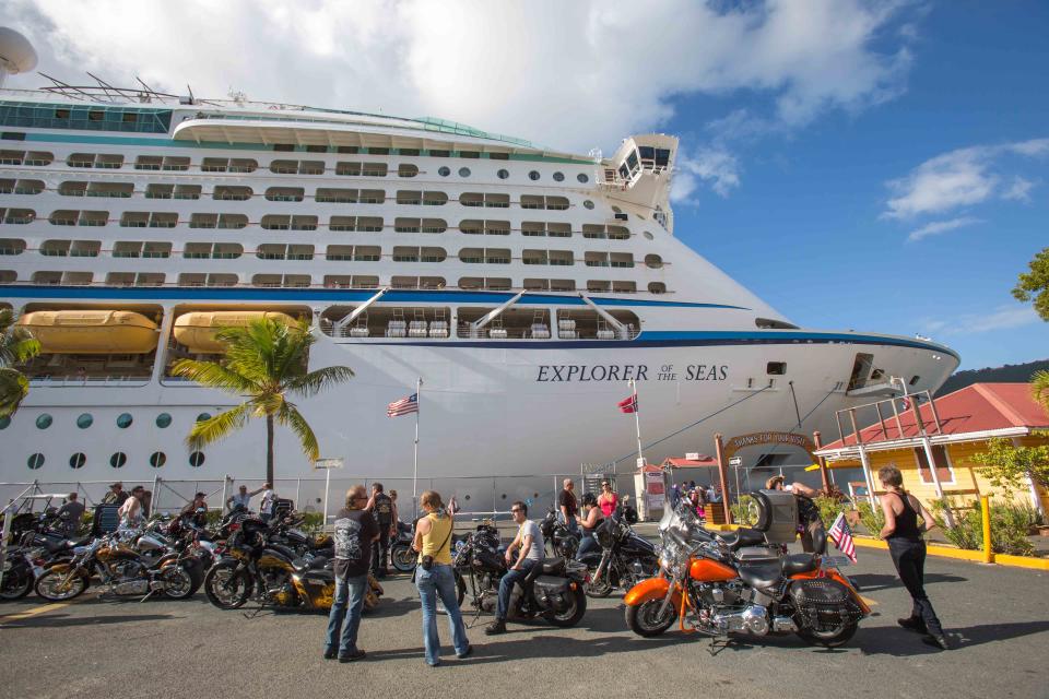 Passengers from a motorcycle cruises' tour group, prepare to board the Royal Caribbean International's Explorer of the Seas, docked at Charlotte Amalie Harbor in St. Thomas, U. S. Virgin Islands, Sunday, Jan. 26, 2014. Health officials have boarded the cruise liner to investigate an illness outbreak that has stricken at least 300 people with gastrointestinal symptoms including vomiting and diarrhea. Over 13 of the 34 motorcycle riders fell ill during the trip. (AP Photo/Thomas Layer)