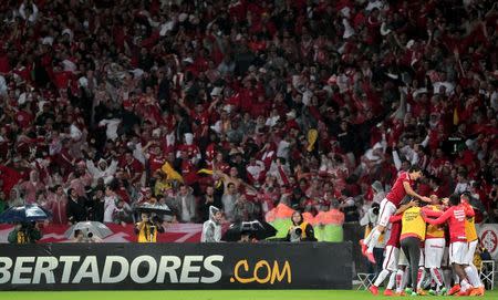 Players of Brazil's Internacional celebrate their second goal against Colombia's Santa Fe during their Copa Libertadores soccer match in Porto Alegre, Brazil, May 27, 2015. REUTERS/Diego Vara