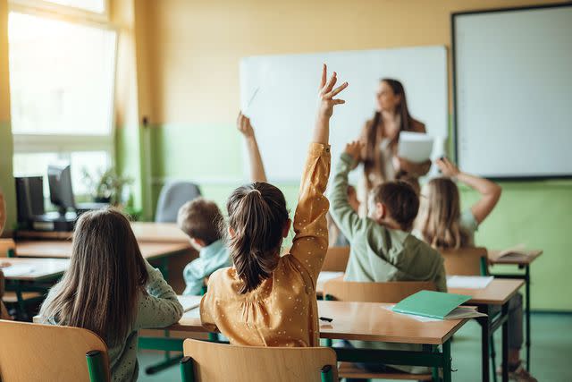 <p>Getty</p> Stock photo of a teacher engaging with students.