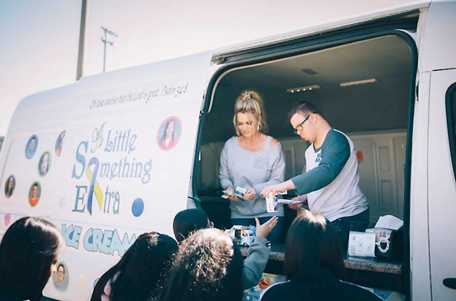 Hunter Norwood and his mother, Michelle Norwood, dispense tasty treats from their A Little Something Extra ice cream truck.