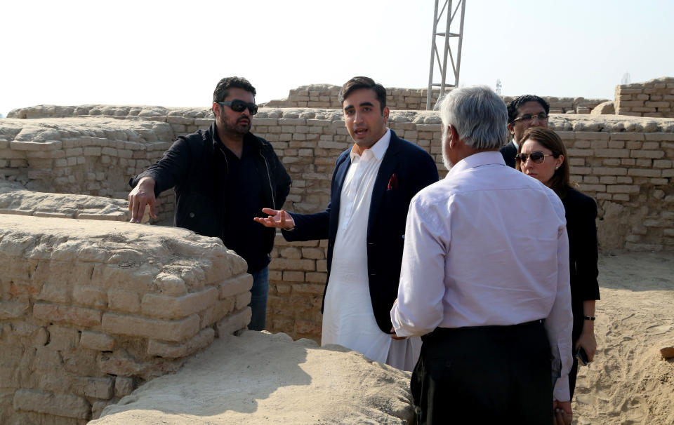In this Thursday, Jan. 30, 2014 photo provided by Bilawal House, Bilawal Bhutto Zardari, second from left, son of Pakistan's assassinated Prime Minister Benazir Bhutto visits the site of Sindh Cultural Festival in ruins of Mohenjodaro in Pakistan. A plan by Bilawal to hold a cultural festival at an ancient site in southern Pakistan has sparked controversy, with several leading archaeologists saying Friday it could damage the ruins. (AP Photo/Bilawal House)