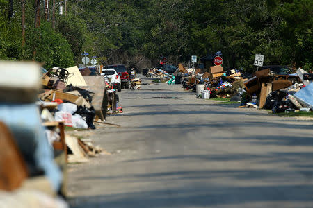 FILE PHOTO: Flood-damaged contents from people's homes line the street following the aftermath of tropical storm Harvey in Wharton, Texas, U.S., September 6, 2017. REUTERS/Mike Blake/File Photo