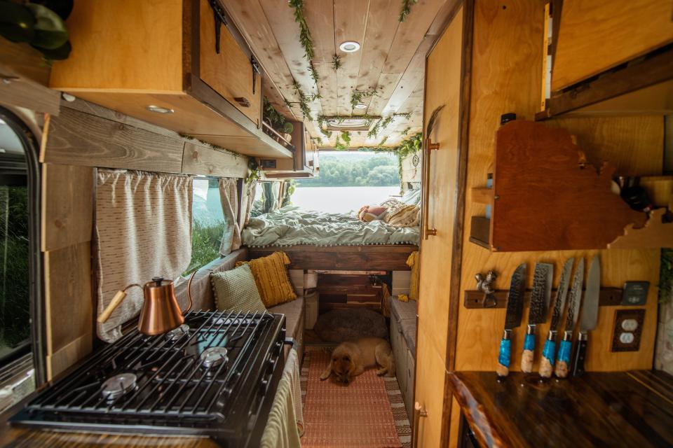 A view inside the van shows the kitchen, living space, and bedroom.