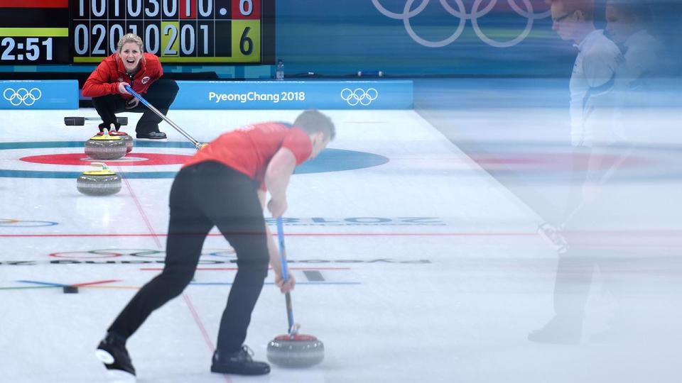 <p>Norway's Kristin Skaslien yells as teammate Norway's Magnus Nedregotten brushes the ice during the curling mixed doubles round robin against Finland.</p>