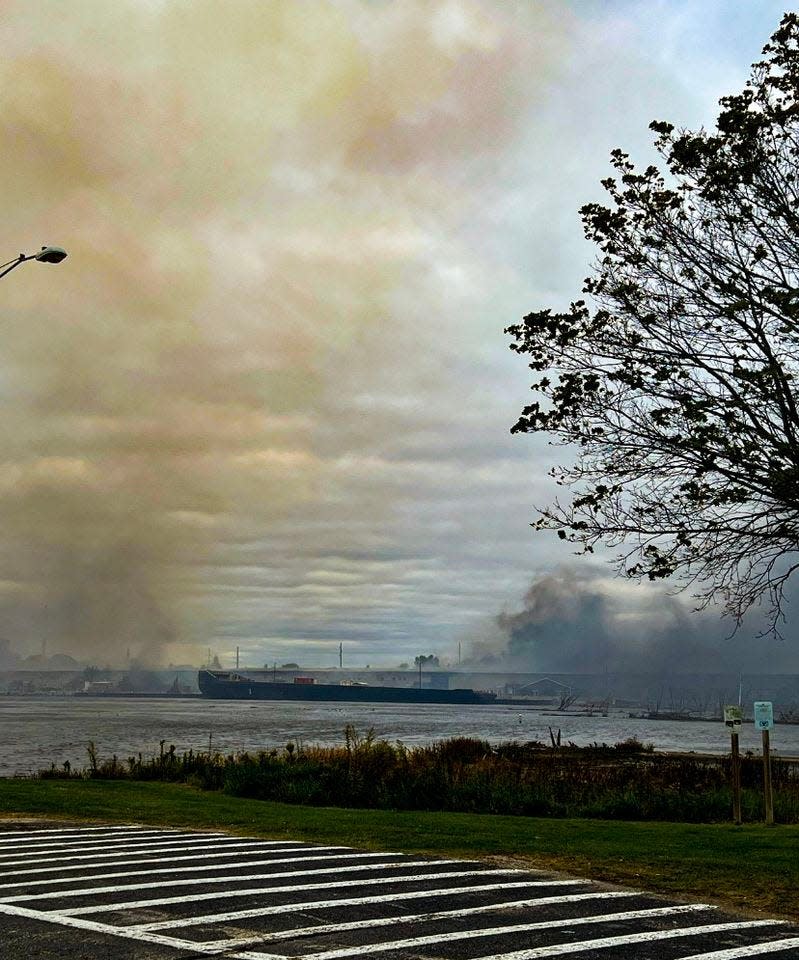 A plume of smoke rises over Menominee during a fire at Resolute Forest Products Oct. 7, 2022, in Menominee, Mich. The smoke also caused air quality concerns in neighboring Marinette, Wis.