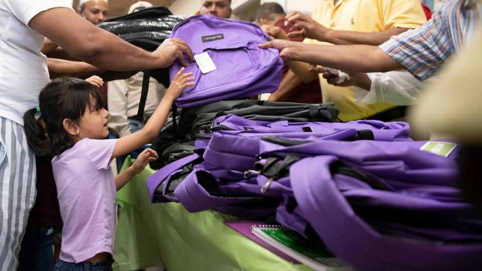 Manha Mobin, 4 of Atlantic City, receives a backpack containing school supplies during a school supply giveaway held at the Bangladesh Community Center in Atlantic City on Wednesday, August 24, 2022.