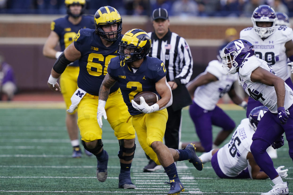 Michigan running back Blake Corum (2) rushes during the second half of an NCAA college football game against Northwestern, Saturday, Oct. 23, 2021, in Ann Arbor, Mich. (AP Photo/Carlos Osorio)