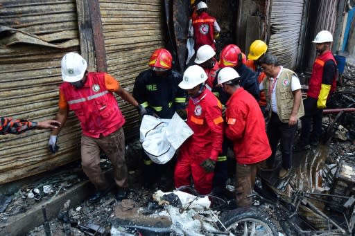 Firefighters have been searching for bodies in the charred buildings