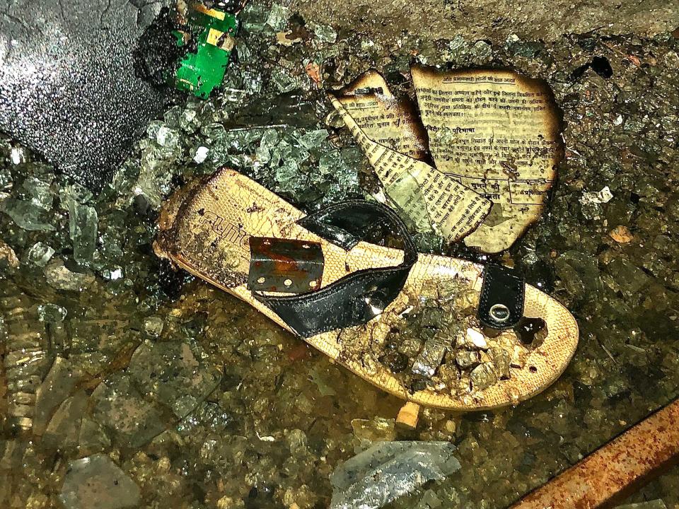 A woman's sandal laying outside a New Delhi commercial building that caught fire on May 13, 2022. The fire left 27 dead. / Credit: Arshad Zargar