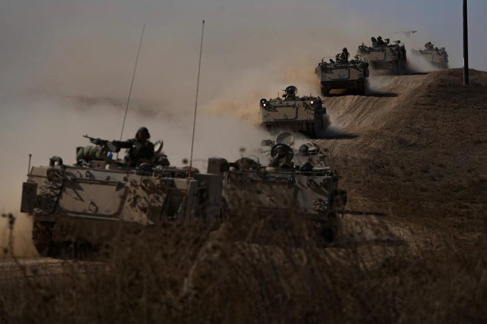 Israeli tanks and armoured vehicles head towards the Gaza Strip border in southern Israel (AP)