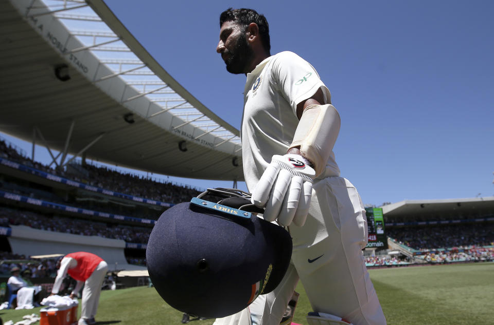 India's Cheteshwar Pujara walks off after he caught out for 193 runs against Australia on day 2 during their cricket test match in Sydney, Friday, Jan. 4, 2019. (AP Photo/Rick Rycroft)