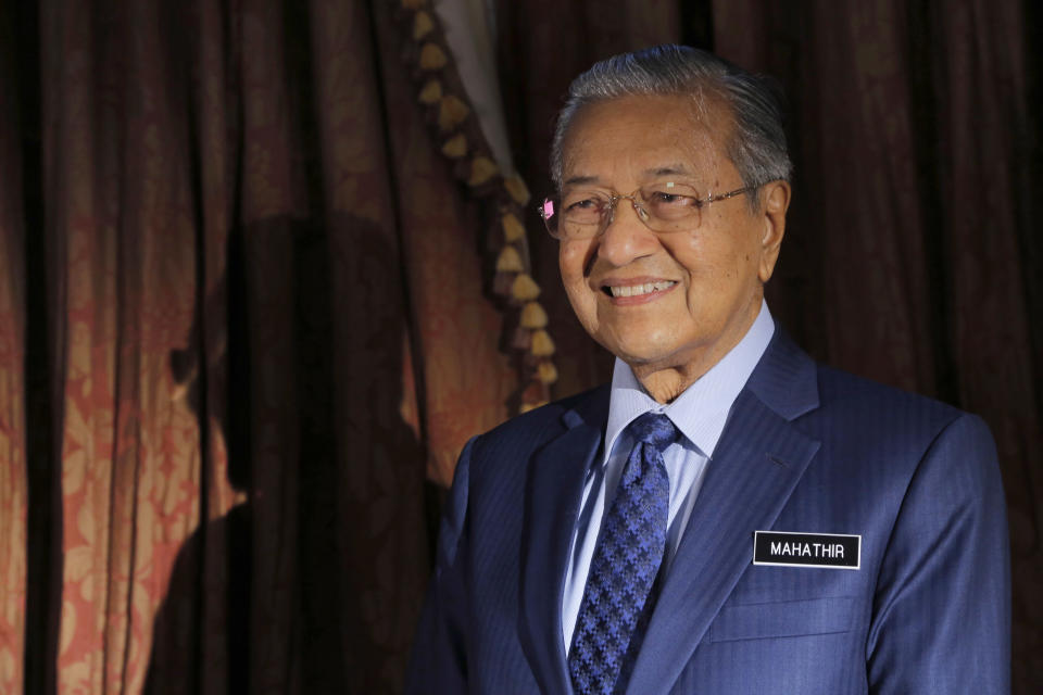 CORRECTS SPELLING OF PRIME MINISTER'S NAME - Malaysia's Prime Minister Mahathir Mohamad poses for a portrait after an interview with The Associated Press in Putrajaya, Malaysia, Monday, Aug. 13, 2018. Mahathir said he will seek to cancel multibillion-dollar Chinese-backed infrastructure projects that were signed by his predecessor as his government works to dig itself out of debt, and he blasted Myanmar’s treatment of its Rohingya minority as "grossly unjust." (AP Photo/Yam G-Jun)