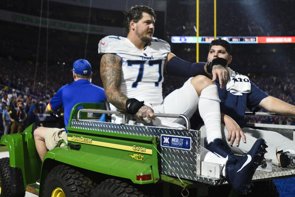 FILE - Tennessee Titans offensive tackle Taylor Lewan (77) is carted off the field during the first half of an NFL football game against the Buffalo Bills, Monday, Sept. 19, 2022, in Orchard Park, N.Y. A three-time Pro Bowl left tackle released by the Tennessee Titans in February over a failed physical issue is suing renowned orthopedist Dr. James Andrews for medical malpractice after the October 2020 surgery repairing his torn right ACL left him with “severe and permanent” damage. Attorneys for Taylor Lewan filed the lawsuit Tuesday night, May 2, 2023, in circuit court in Ecambia County, Florida. (AP Photo/Adrian Krau, File)