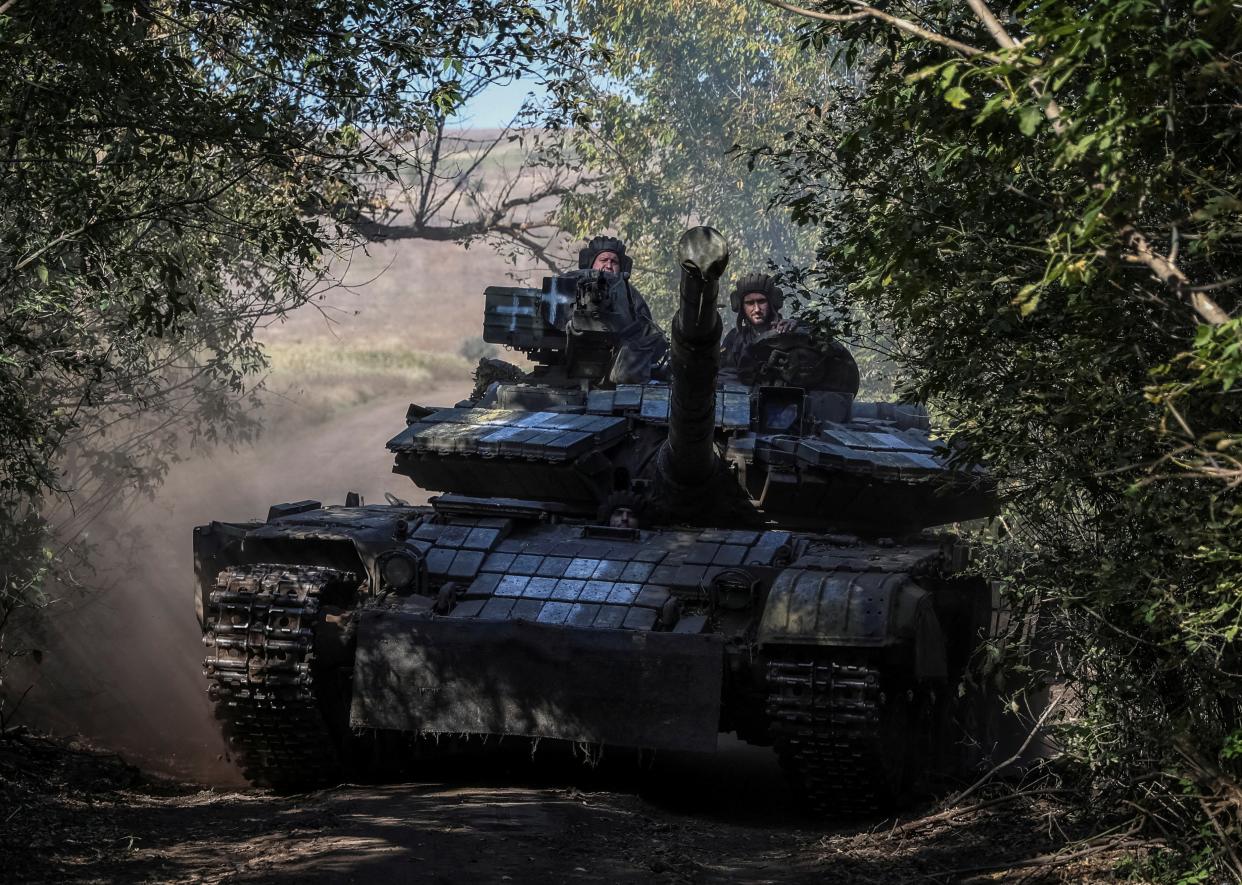 Ukrainian servicemen ride a tank in Donetsk region, eastern Ukraine (REUTERS)