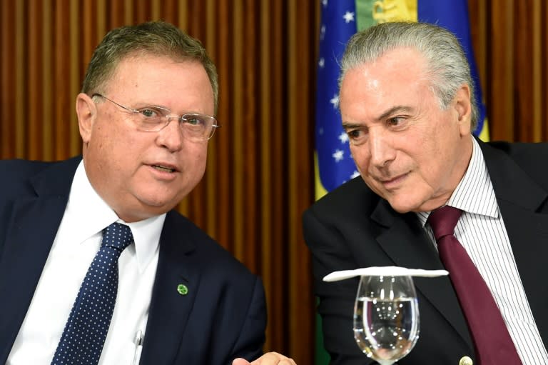 President Michel Temer (R) and his Agriculture Minister Blairo Maggi talk during a meeting with ambassadors from countries that import Brazilian meat, at Planalto Palace in Brasilia, on March 19, 2017