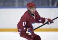 Russia's President Vladimir Putin takes part in a friendly ice hockey match in the Bolshoi Ice Palace near Sochi January 4, 2014. Putin has eased curbs on demonstrations in the Winter Olympics venue of Sochi in a gesture likely to burnish Russia's image ahead of an event dogged by security and human rights worries. REUTERS/Alexei Nikolskiy/RIA Novosti/Kremlin (RUSSIA - Tags: POLITICS SPORT OLYMPICS ICE HOCKEY) ATTENTION EDITORS - THIS IMAGE HAS BEEN SUPPLIED BY A THIRD PARTY. IT IS DISTRIBUTED, EXACTLY AS RECEIVED BY REUTERS, AS A SERVICE TO CLIENTS