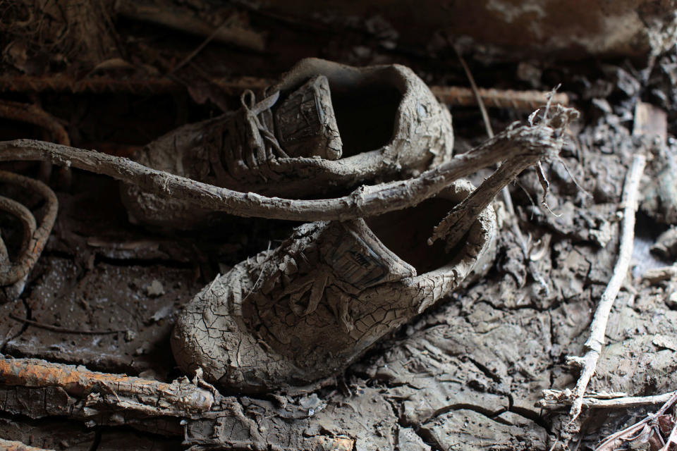 <p>A pair of shoes are seen inside a house filled with mud, after the island was hit by Hurricane Maria in Toa Baja, Puerto Rico, Oct. 16, 2017. (Photo: Alvin Baez/Reuters) </p>