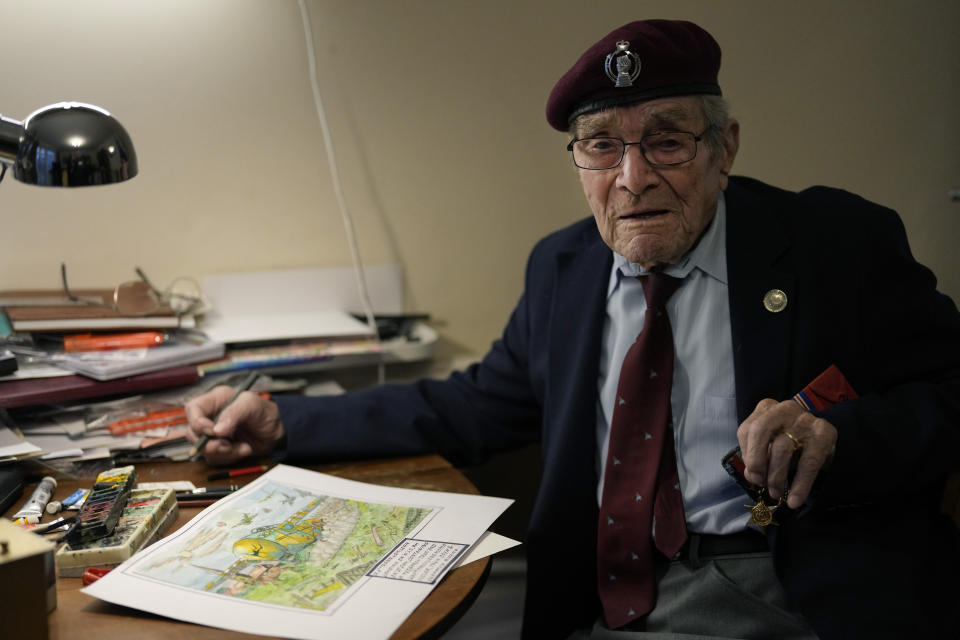 FILE - D-Day veteran Bill Gladden shows off one of his paintings, that depicts the type of glider in which he landed in Normandy on D-Day, at his home in Haverhill, England, Friday, Jan. 12, 2024. Gladden, one of the dwindling number of veterans who took part in the landings that kicked off the campaign to liberate Western Europe from the Nazis during World War II, died Wednesday, April 24, 2024, his family said. He was 100. (AP Photo/Alastair Grant, File)