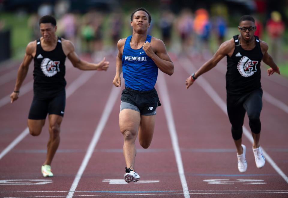 Memorial's Anthony Brodie, center, crosses the finish line ahead of Harrison's Khalil Durden, left, and Aiden Hamilton in the preliminary of the 100 Meter Dash during the Evansville Central IHSAA Boys Regional Track & Field Meet at Central Stadium Thursday evening, May 26, 2022. Brodie later won the final with a time of 10.75.