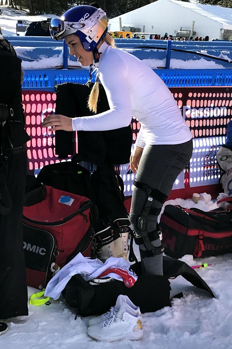 United States' Lindsey Vonn wears knee braces in the finish area of an alpine ski, women's World Cup downhill in Cortina D'Ampezzo, Italy, Friday, Jan. 18, 2019. Lindsey Vonn made an uncharacteristic mistake midway down and finished tied for 15th in a World Cup downhill on her return from injury on Friday. (AP Photo/Andrew Dampf)