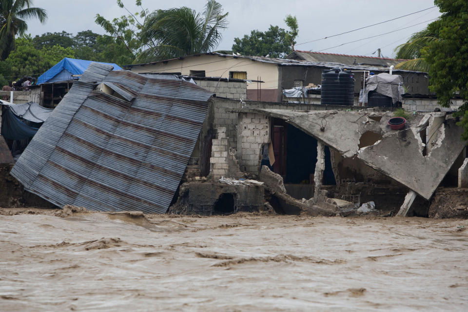 Damaged houses are seen on the shore of a river after heavy rains brought by Hurricane Sandy in Port-au-Prince, Haiti, Thursday, Oct. 25, 2012. Sandy was blamed for the death of an elderly man in Jamaica who was crushed by a boulder. Another man and two women died while trying to cross storm-swollen rivers in southwestern Haiti. (AP Photo/Dieu Nalio Chery)