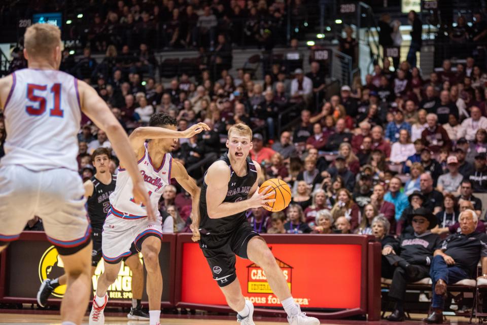 Bradley center Rienk Mast braces for an oncoming SIU star Marcus Domask during the Braves 50-48 win at Banterra Center in an MVC game in Carbondale on Sunday, Feb. 19, 2023.