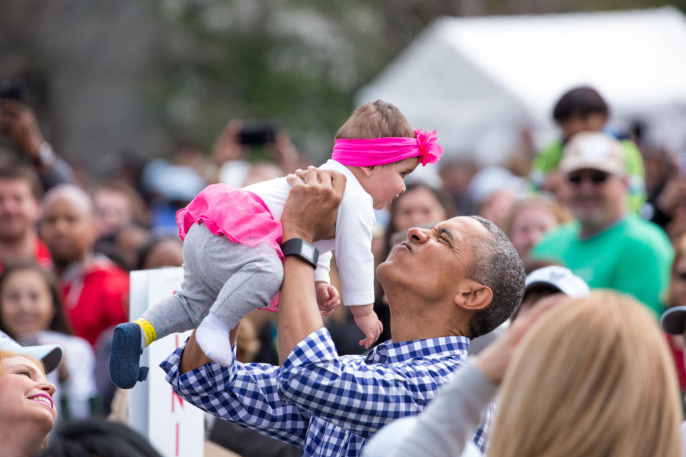 Obama plays with a baby at the 138th Annual Easter Egg Roll at the White House in March 2016. (Photo: NurPhoto via Getty Images)