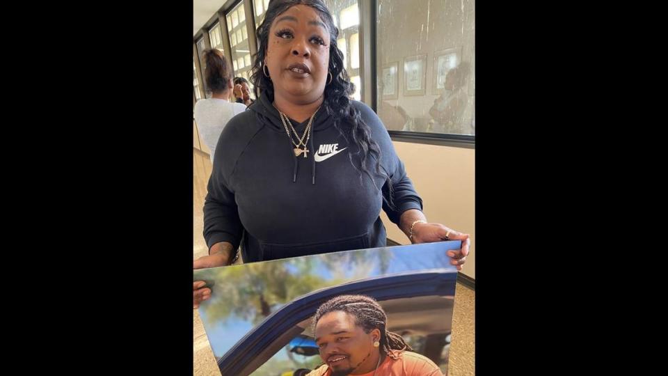 Chastity Gossett holds a photo of her son - Freddie Carrasco Jr., who was killed in a June 2022 shooting on Highway 99 - on Tuesday, Nov. 7, 2023, in Fresno, California. ROBERT RODRIGUEZ/rrodriguez@fresnobee.com