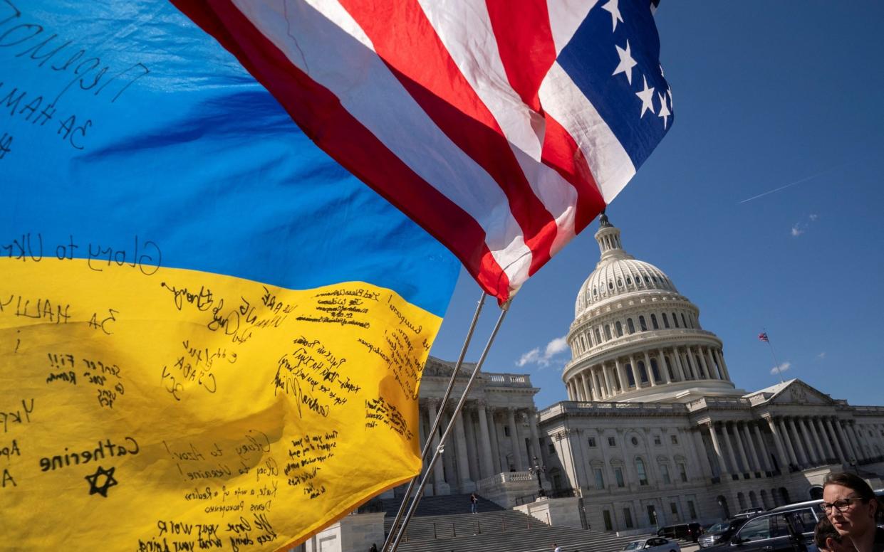 Flags flutter as pro-Ukrainian supporters demonstrate outside the U.S. Capitol after the U.S. House of Representatives voted on legislation providing $95 billion in security assistance to Ukraine, Israel and Taiwan