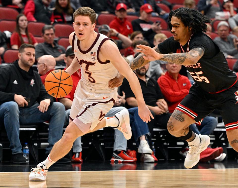 Virginia Tech guard Sean Pedulla (3) dribbles against Louisville guard Skyy Clark (55) during the first half at KFC Yum! Center.