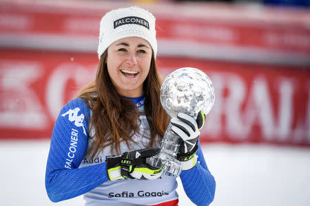 Alpine Skiing - FIS Alpine Skiing World Cup - Women's Downhill - Are, Sweden - March 14, 2018. Sofia Goggia of Italy celebrates with the trophy after winning the FIS Downhill World Cup, after placing second in the women's final race. Anders Wiklund/TT News Agency via Reuters