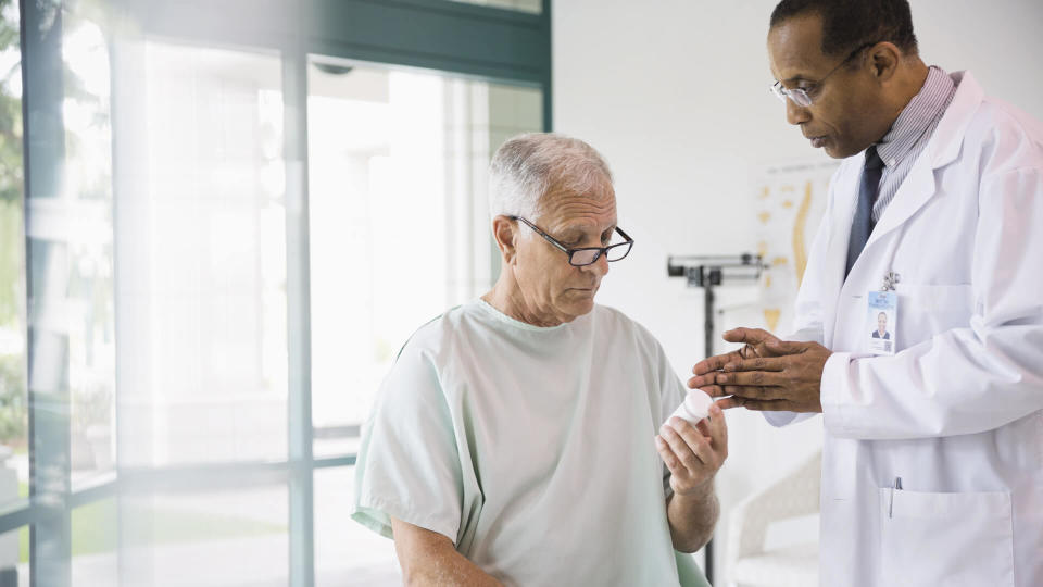 Doctor discussing prescription with senior patient.