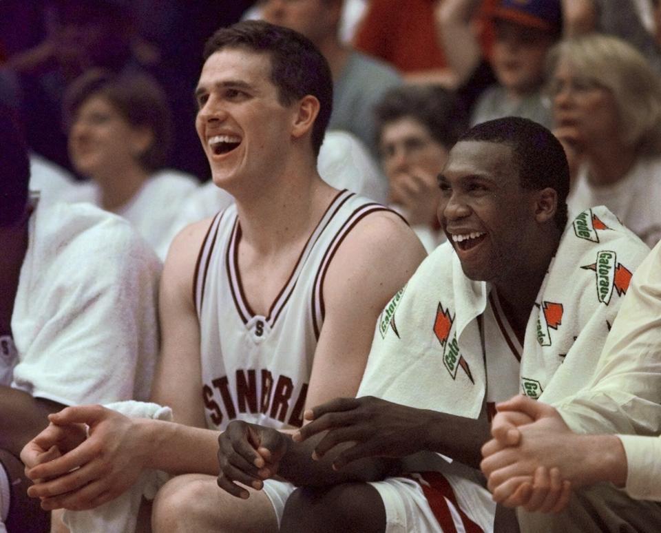 FILE -Stanford forward Mark Madsen, left, and guard David Moseley laugh in the closing minutes of Stanford's 101-50 win over California, Saturday, Feb. 19, 2000, in Stanford, Calif. California is hiring a former Stanford star to revive its struggling basketball program. The Golden Bears have agreed to a contract with Mark Madsen to replace the fired Mark Fox following the worst season in school history. (AP Photo/Paul Sakuma, File)