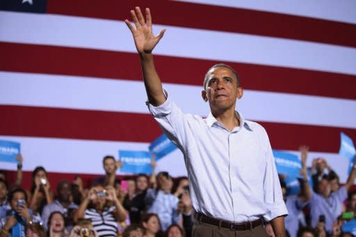 US President Barack Obama waves to supporters at a campaign rally September 8, 2012 in Kissimmee, Florida. Obama was to woo Florida voters Sunday after Republican Mitt Romney thrust religion to the center of the White House race as he sought to underscore the rivals' different approach to traditional values