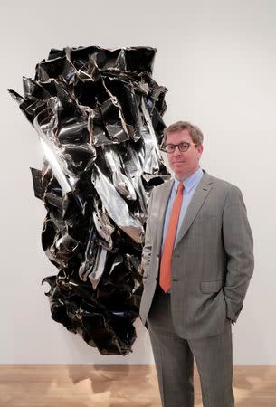 Marc Glimcher, President and CEO of Pace, poses in front of "Free Chee (Dedicated to my #2 son Jesse Claude)" (1999) of U.S. artist John Chamberlain during the Art Basel in Basel, Switzerland, June 13, 2018. PREUTERS/Moritz Hager
