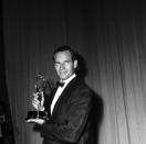 <p>Actor Charlton Heston smirks as he holds his Emmy for Outstanding Lead Actor in <em>Studio One in Hollywood</em>.</p>