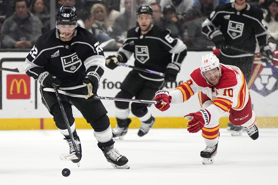 Los Angeles Kings left wing Kevin Fiala, left, takes the puck as Calgary Flames center Jonathan Huberdeau reaches in during the second period of an NHL hockey game Thursday, April 11, 2024, in Los Angeles. (AP Photo/Mark J. Terrill)