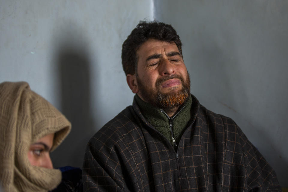 Mushtaq Ahmad Wani, father of 16-year-old Athar Mushtaq, grieves while talking to Associated Press in Bellow, south of Srinagar, Indian controlled Kashmir, Tuesday, Jan. 5, 2021. On the last week of 2020, Indian government forces killed Athar and two other young men during a controversial gunfight on the outskirts of the Indian-controlled Kashmir’s main city. Police did not call them anti-India militants but “hardcore associates of terrorists." They later buried them at a graveyard in a remote mountainous tourist resort miles away from their ancestral villages. Athar was the latest Kashmiri to be buried in a far-off graveyard after Indian authorities in a new controversial policy in 2020 started to consign blood-soaked bodies of scores of Kashmiri suspected rebels to unmarked graves, denying the mourning families a proper funeral and a burial. (AP Photo/ Dar Yasin)