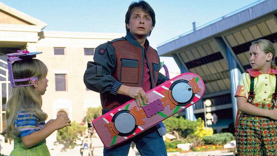 Marty McFly holds his hoverboard in Back to the Future II.