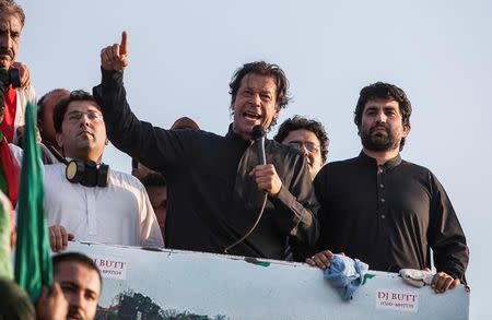 Imran Khan (C), the Chairman of the Pakistan Tehreek-e-Insaf (PTI) political party, addresses supporters during the Revolution March in Islamabad August 31, 2014. REUTERS/Faisal Mahmood/File Photo