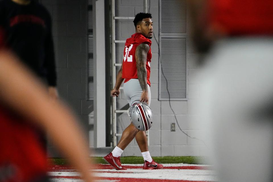 Mar 7, 2023; Columbus, Ohio, USA;  Ohio State Buckeyes running back TreVeyon Henderson (32) walks off the fied after stretching during the first day of spring football drills. Mandatory Credit: Adam Cairns-The Columbus Dispatch