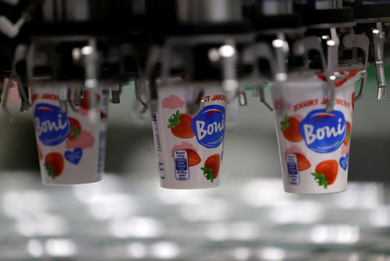 A robotic arm sorts yogurts at a distribution centre near Prague